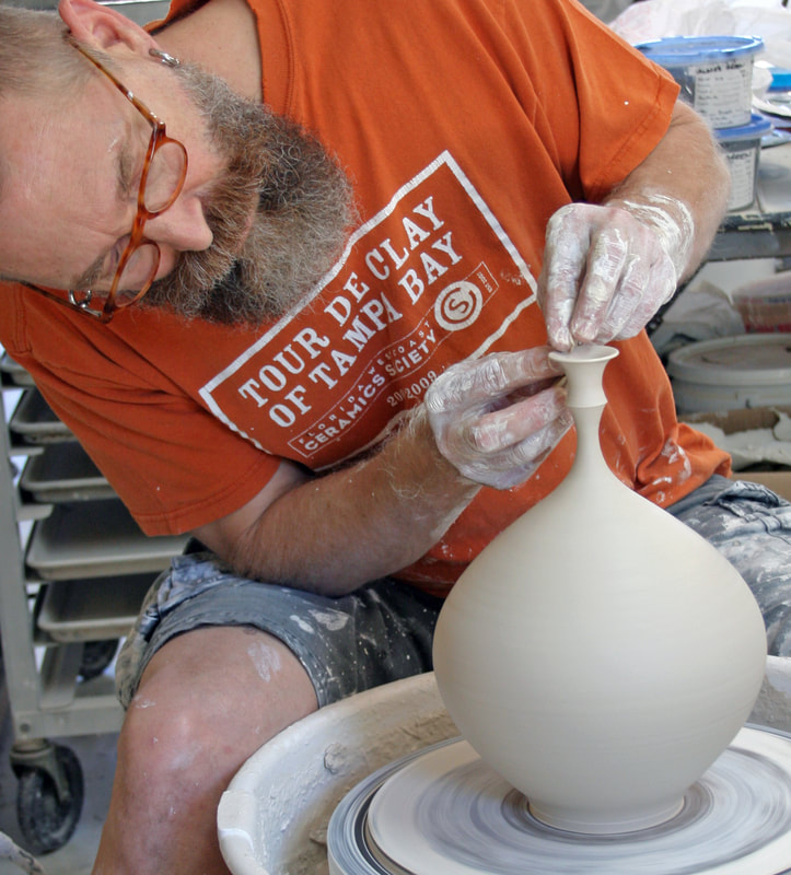 Man making a clay vase